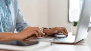 Un uomo che utilizza il suo computer per delle ricerche